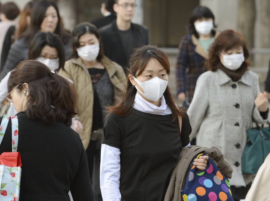 Masked: Women wearing masks in Japan for protection against viruses and pollution. 