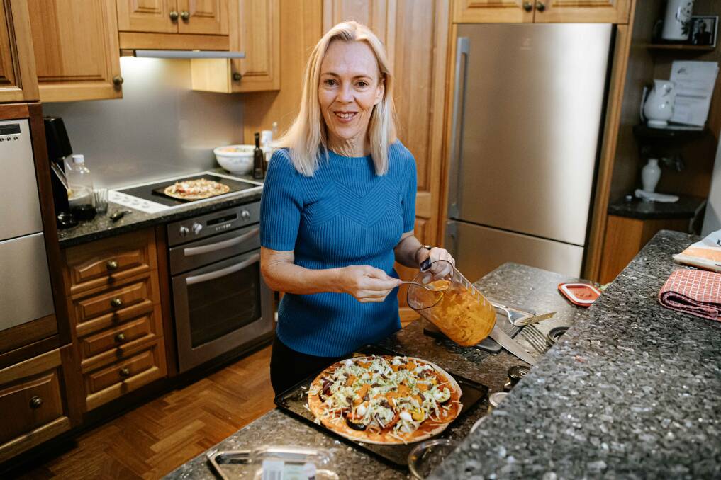 Nutrition expert Clare Collins cooking dinner in her kitchen. Picture by Bronte Godden 