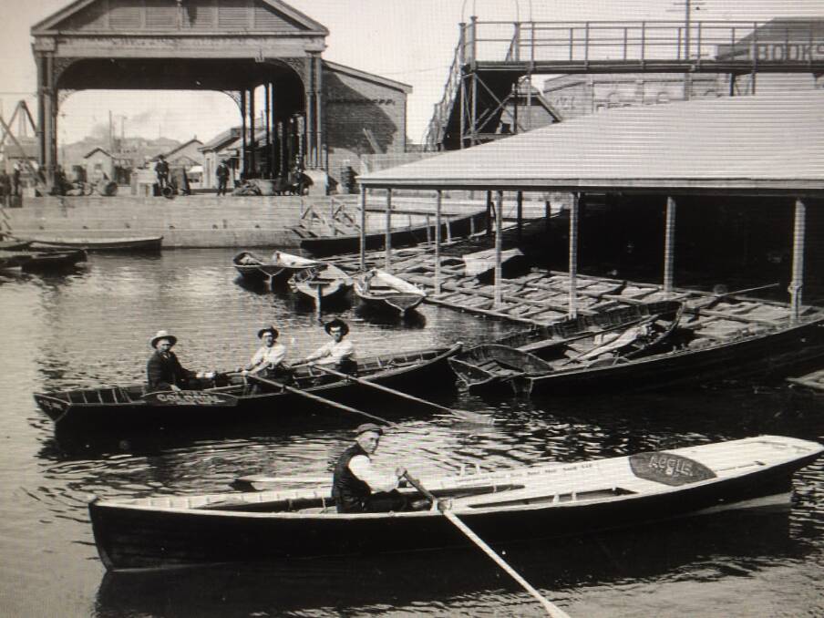 Old Times: Watermen at what is thought to be the old Perkins Street boat harbour, around 1910. Picture: Newcastle Region Library 