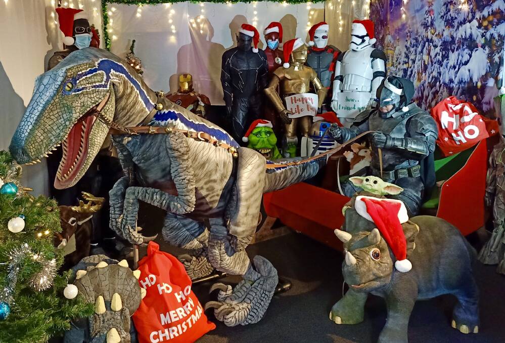 New Christmas: Blue the dinosaur from Jurassic World pulling the sled, as Santa - dressed as Armoured Batman - takes the reigns. 