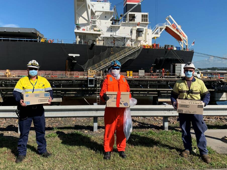 Port Waratah workers with the gift boxes. 