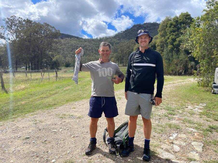 Walk On: Peter Worgan, with workmate Jack Mitchell, on the trail of a 100-kilometre walk they did through the Hunter on Saturday. 