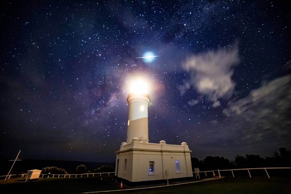 Mystery: An unexplained blue glow with a streak of light through it in the sky above Norah Head Lighthouse. Picture: Jeremy Farish 