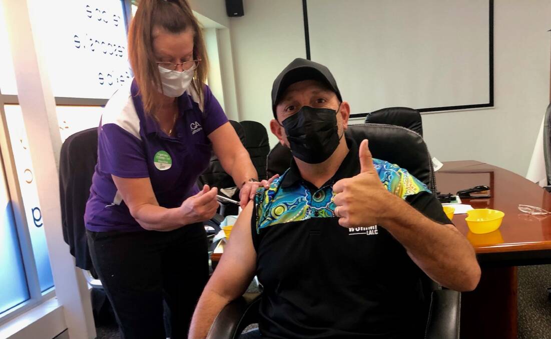 Jabbed: Worimi Local Aboriginal Land Council's Andrew Smith receiving his first Pfizer vaccine on Tuesday. 