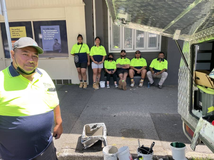 STAN THE MAN: Stan Masima, head of Thornton firm Stan Painting Services, gets ready to start on a nearby job as some of his volunteer crew today - Nancy Fifita, Vai Masima, Noela Masima, Nigel Masima, Junior Masima and Folau Koto, take a break from their endeavours. Picture: Ian Kirkwood