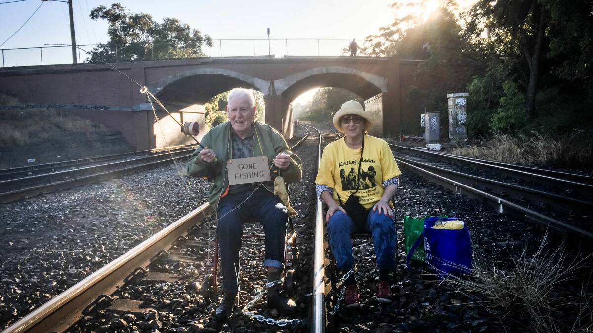 DIRECT ACTION: Bill Ryan, 96, and Susie Gold, 75, chained to the tracks leading to the Carrington Coal Terminal on Saturday morning. Protest organisers say that when "injustice becomes law, resistance becomes duty".