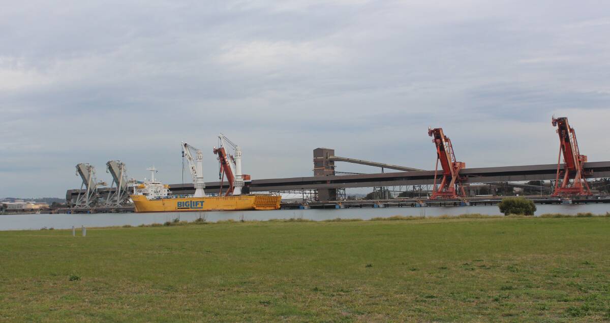 LANDMARK: Carrington Coal Terminal and the Happy Buccaneer preparing to take one of the old coal loaders, viewed from Walsh Point on Kooragang Island. Pictures: PWCS.