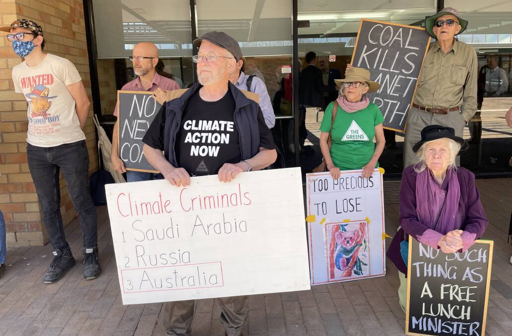 The protesters said the NSW government had approved at least 26 new or expanded fossil fuel projects since the Paris Agreement was signed in 2016.