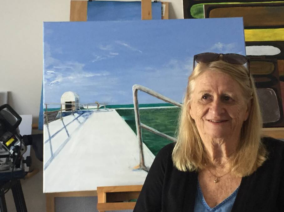 STILL STOKED!: Pam Lynch yesterday at the Broadmeadow home of her good friend Leone Picton, who painted the scene of Merewether Baths.