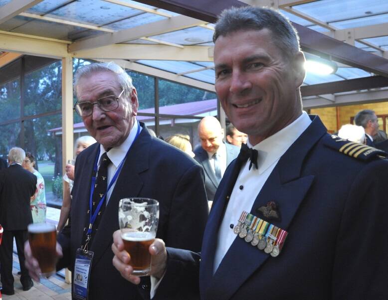 DECORATED: Air Commodore (retired) Terry van Haren, pictured here at a 2016 centenary dinner for the RAAF's Williamtown-based 3 Squadron. Mr van Haren was commanding officer of 3 Squadron from 2008 to 2011 in a military career that spanned 35 years. He was awarded a Distinguished Service Medal for his combat leadership in 75 Squadron during Operation Falconer in 2003 during the Iraq War. With him is 3 Squadron engine fitter Slim Moore, a veteran of the North African Battle of Alamein, mentioned in despatches.