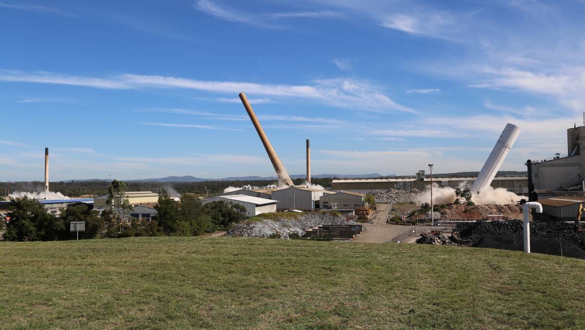 PRECISION TIMING: Four of the Kurri smelter's stacks being brought down in simultaneous controlled demolitions in May 2019. Picture: Ansol Tech