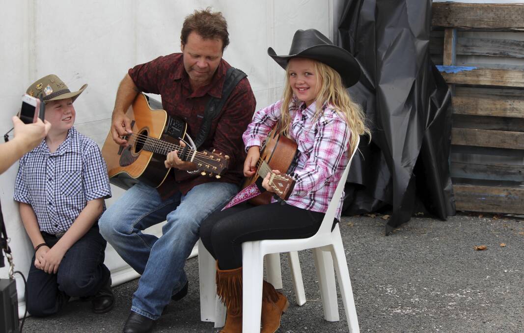 The annual Tamworth Country Music Festival has been postponed until April because of COVID fears - one of many casualties of the Omicron surge. Picture shows Troy Cassar-Daley and two young fans.