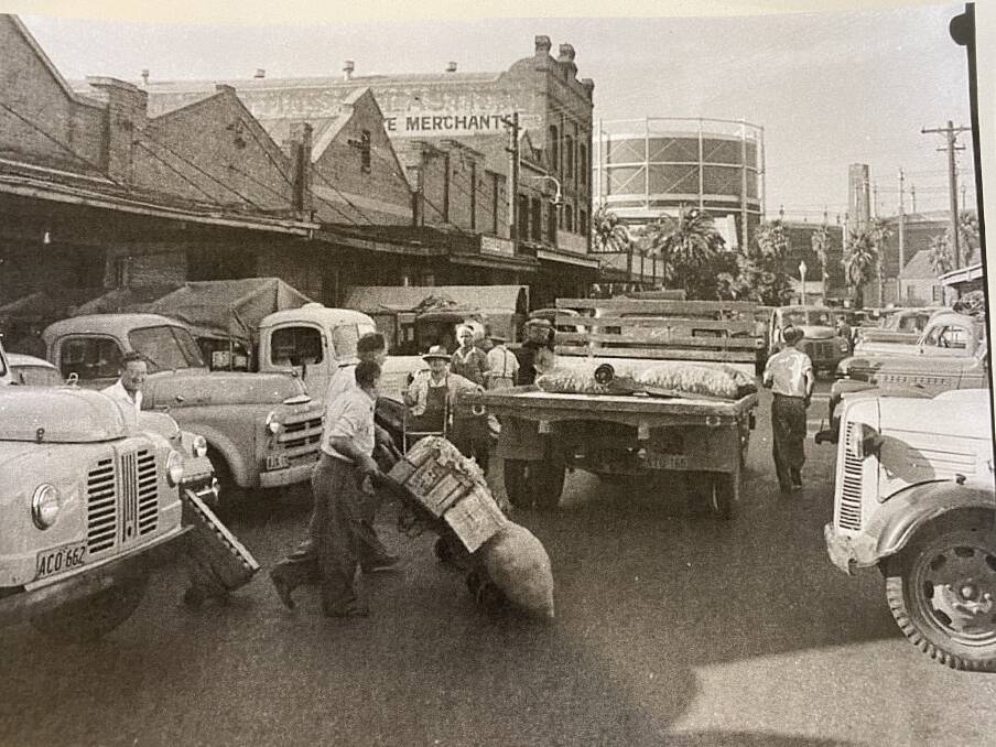GAS WORKS: The Steel Street, Newcastle, fruit markets, with the gas holder where the newer, Woolworths side of Marketown stands now. Picture: Courtesy Richard Hamment