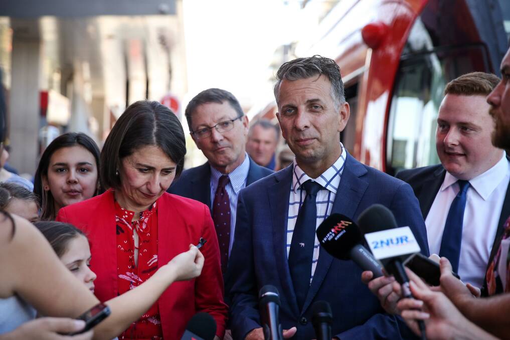 THE BIG OCCASION: Gladys Berejiklian and Andrew Constance, with their Liberal Scot MacDonald between them, at the official opening of the Newcastle light rail on Friday, February 15, 2019. The symbol at the centre of Mr Constance's dark tie was a white elephant. He believes Canberra beckons. The future for Ms Berejiklian is not so assured.