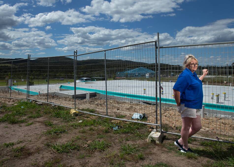 ABANDONED SITE: Sara Conlan at the concrete slab in Raymond Terrace, where her dream home was supposed to be ready to move into in February. Picture: Marina Nei