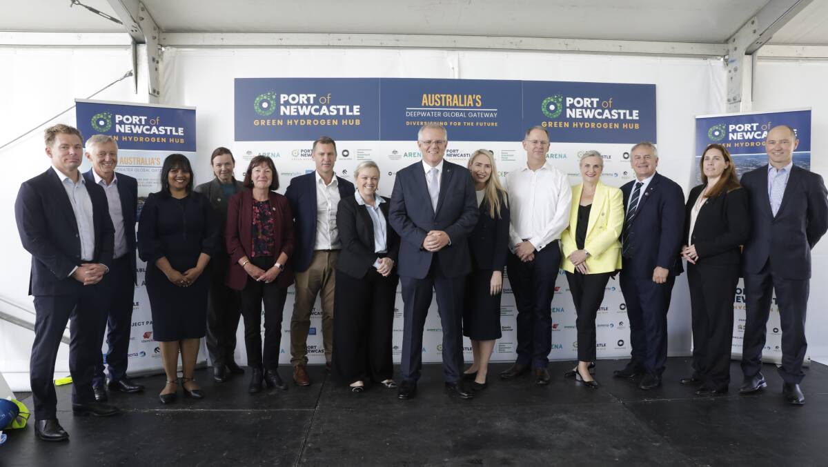 PORT PLAYERS: Prime Minister Scott Morrison flanked by Liberal Party candidates Nell McGill and Brooke Vitnell with Port of Newcastle CEO Craig Carmody (white shirt) to the right, next to Liberal Senator Hollie Hughes and University of Newcastle Vice Chancellor Alex Zelinsky, with representatives of other organisations in the 'hydrogen hub: Macquarie Group, Idemitsu, Snowy Hydro, Jemena, Keolis Downer and Lake Macquarie City Council.