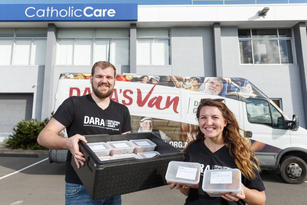  BRIDGING SOCIAL DISTANCE: Baden Ellis and Bree Evans with meals to be delivered by car while 'DARA's Van' is off the road during the pandemic. Rank and file members of the Maritime Union of Australia's Newcastle branch gave DARA $3000 to help with feeding people during the coronavirus lockdowns. Picture: Max Mason-Hubers