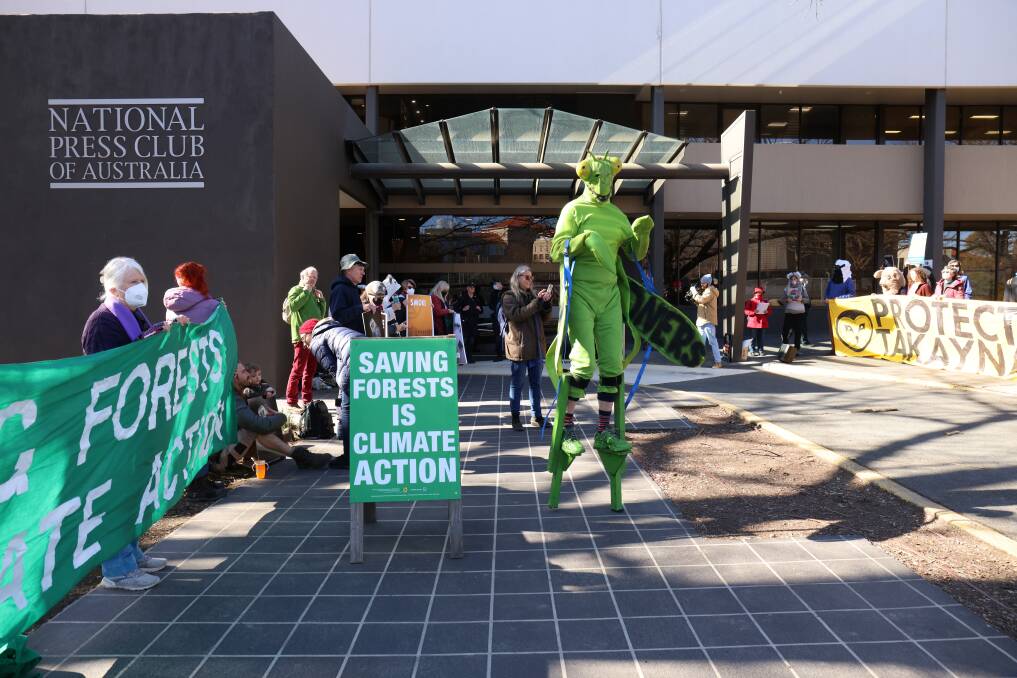WE'RE ALL GREEN, NOW: Climate activists at the National Press Club today, outside the launch of the environment report. Picture: James Croucher