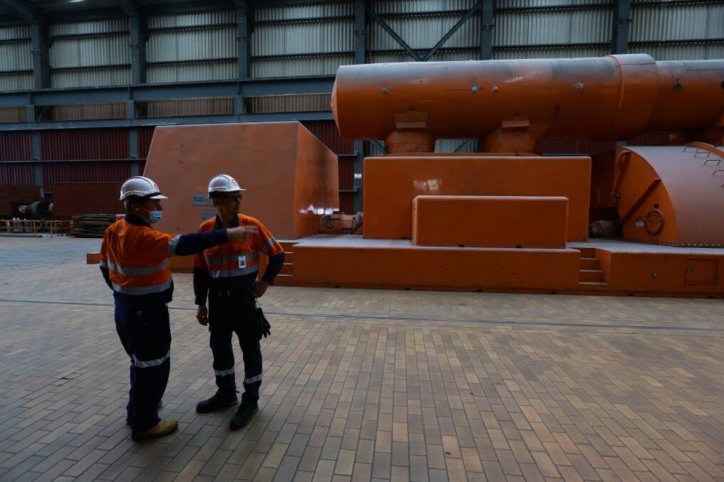 Two Origin Energy employees on one of the turbine floors of the Eraring power station. Picture by Jonathan Carroll