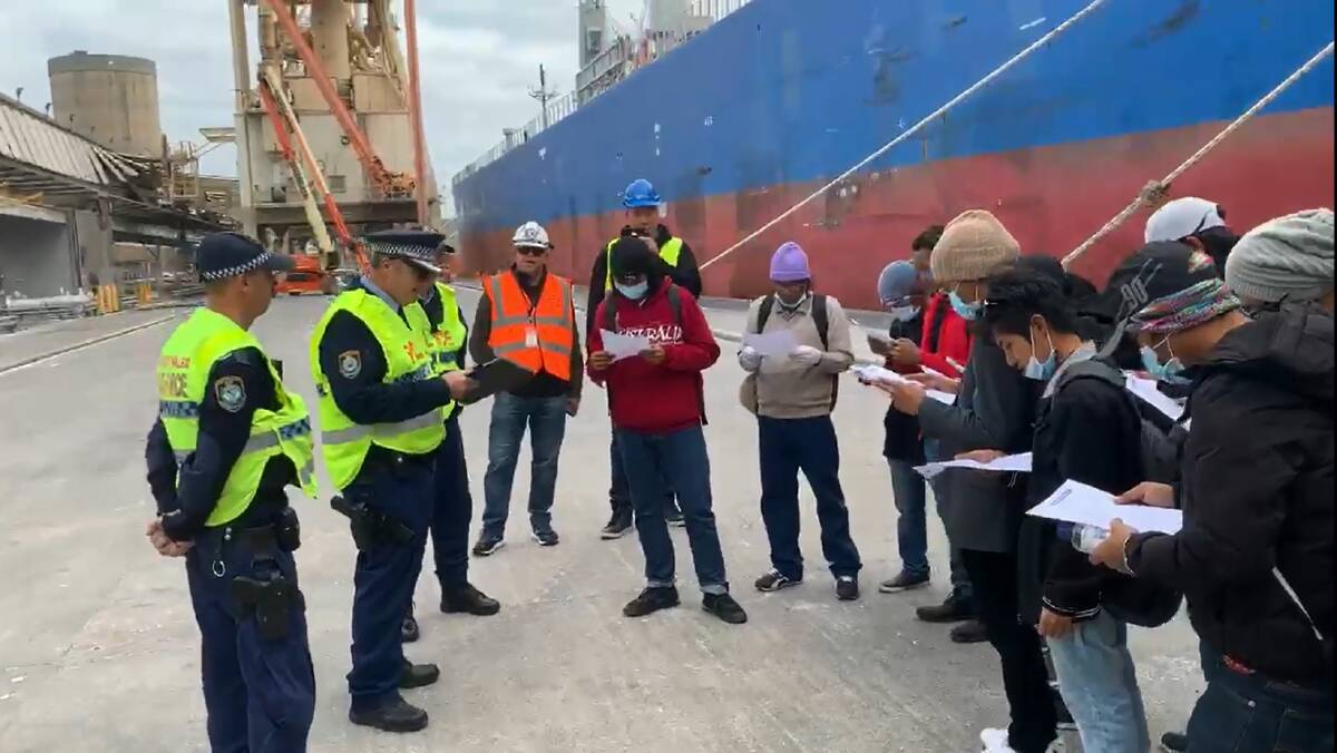 INSTRUCTIONS: NSW Police officers, who provided an escort for the crew of the Unison Jasper, talking with them on Friday before their trip to Sydney. Picture: ITF