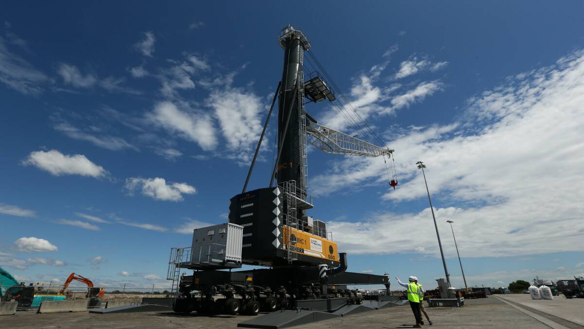 One of the hybrid diesel/electric Liebherr shore cranes that the Port of Newcastle has leased in a $28.4 million deal described at the conference as part of its 'green financing framework. Picture by Jonathan Carroll