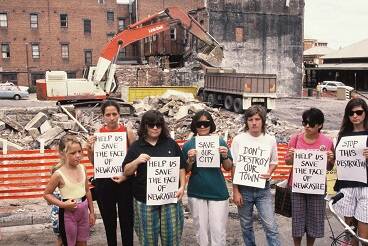 Protesters in front of the site of the demolished George and Carrington buildings, with Newcastle railway station in the background. Picture: David Wicks