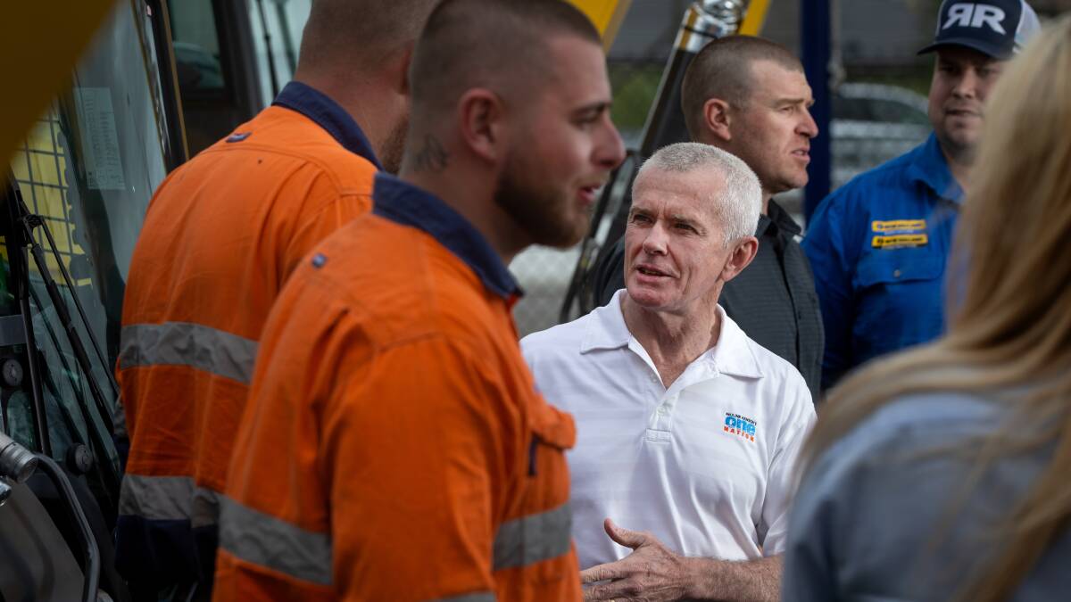 HAPPIER TIMES: January last year, with One Nation Senator Malcolm Roberts and Stuart Bonds pressing the flesh at a Rutherford machinery business. Picture: Marina Neil