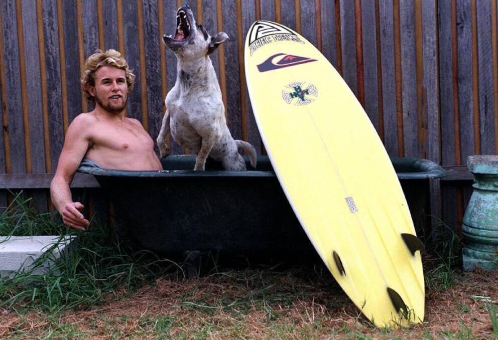 THE HOWLING: Matt Hoy at home with his board and his dog, Potty, in a shot from the Herald files.