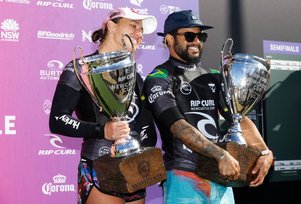 PROUD PAIR: Carissa Moore and Italo Ferreira at the presentation on Saturday after winning the event and taking home trophies with solid lumps of weathered hardwood for bases. Both felt the love of an enthusiastic crowd that left wanting more. Picture: Jonathan Carroll