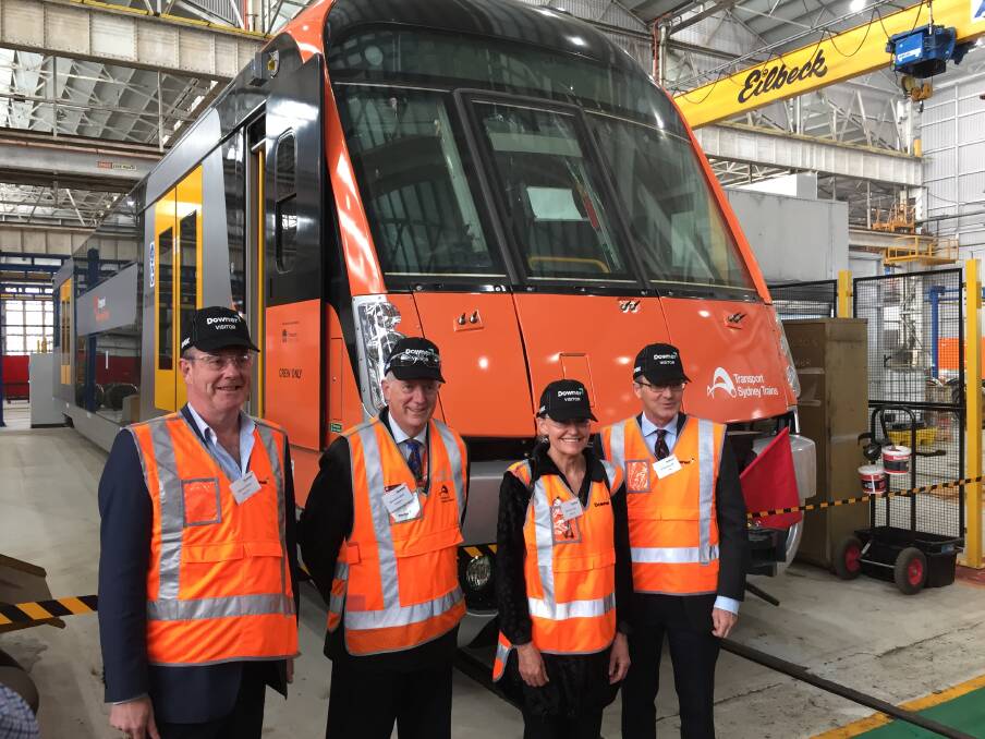 HAPPY TRAVELLERS: Michael Miller, Howard Collins, Sonia Hornery and Scot MacDonald at yesterday's official opening of a $38-million upgrade to Downer Rail's Cardiff facility.