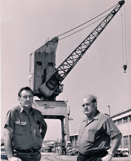  UNION MEN: Don Williams, left, with a colleague, in front of a crane on one of Newcastle's many cargo wharves. Picture: Williams family