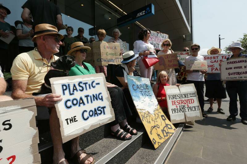 TIES THAT DON'T BIND: Protesters outside the new Newcastle City Council building in December last year about to dump 4500 cable ties on the ground - rubbish collected after the Supercars race. Picture: Simone De Peak