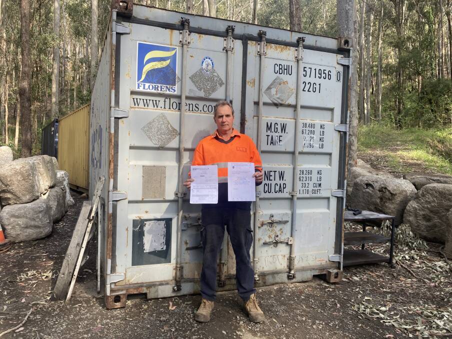 CAUGHT: Keith Smith with paperwork for container he paid for online, but which never arrived. He bought the container behind him to replace it. Picture: Sonja Smith
