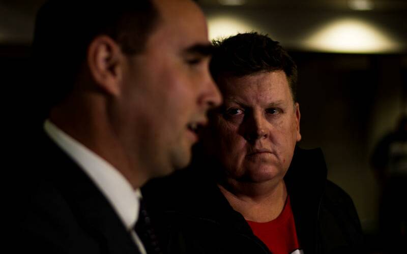 SHAKEUP: Adero lawyers principal Rory Markham with former Mount Arthur mine worker Simon Turner looking on, as the firm's class action against the BHP mine was launched at Beresfield in early 2018. The CFMEU has blasted Adero and other class action firms, arguing they do not have the mine workers' interests at heart. Simon Turner and a group of disaffected Hunter miners say they can trace the growth of the labour hire model back to the CFMEU and its Hunter-based firm United Mining Support Services or UMMS. 