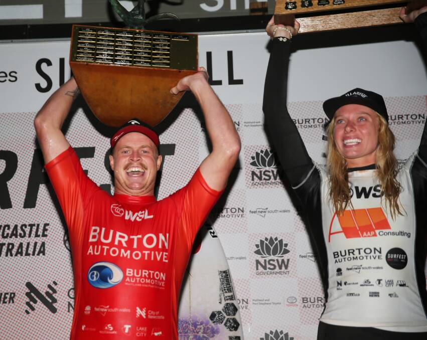 SILVERWARE: The competition ran so long on the first day reverting back to Eastern Standard Time that the presentation was in darkness. Jackson Baker and Macy Callaghan flashing on their wins. Picture: Peter Lorimer/Newcastle Herald