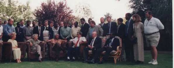 ONCE IN A LIFETIME: Mick Watson, standing on the left in front of Blanche D'Alpuget, seated next to Bob Hawke, listening to Nelson Mandela holding court.