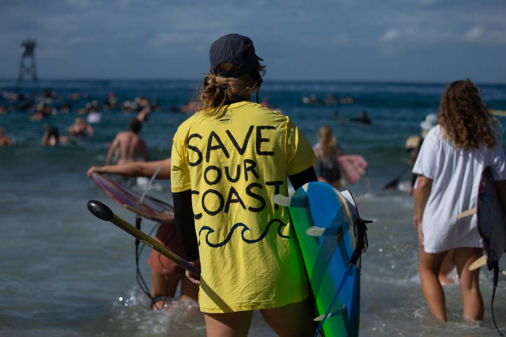 MESSAGE IN A BATTLE: Surfers taking part in the paddle-out. Picture: Marina Neil