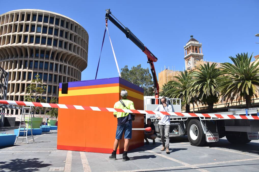 GENTLY DOES IT: The box being eased into place after its semi-trailer journey from Newcastle showground.