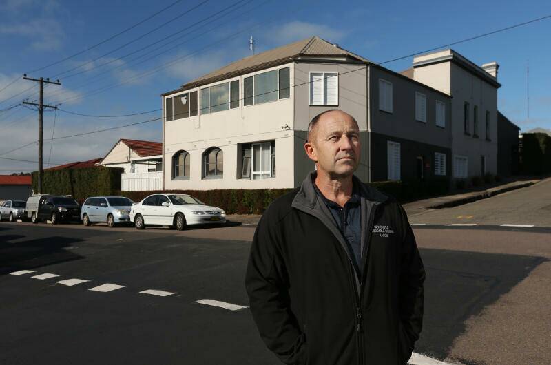 DETERMINED: Aaron Buman outside the Adamstown boarding house, which was originally the Royal Standard Hotel and then a nursing home. 'Maybe they just don't want a boarding house in Adamstown?' he asks. Picture: Simone De Peak