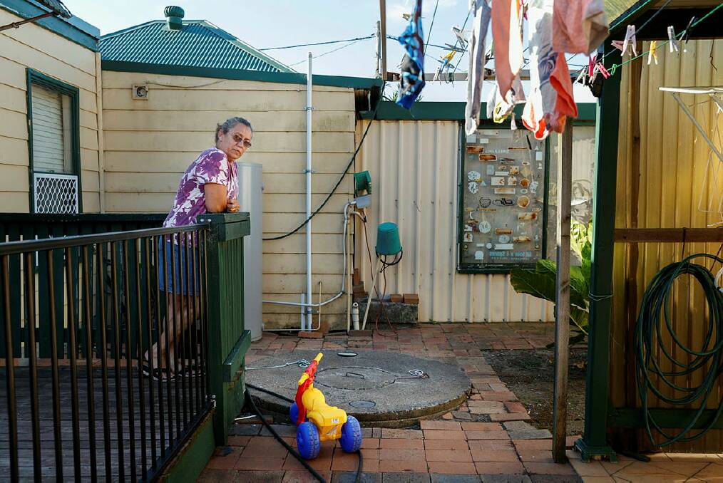 SEE FOR YOURSELF: Rita Grima in her backyard with one of the two septic tanks on her property. She says the smell and the cockroaches can be pretty unbearable at times. Picture: Max Mason-Hubers