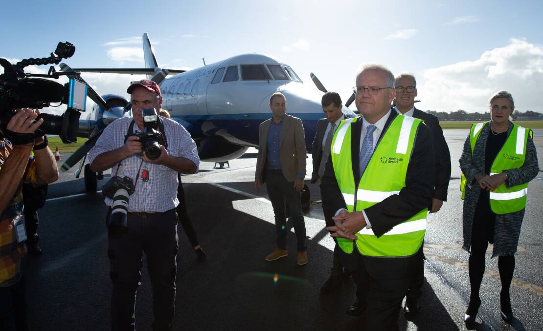 GREEN MACHINE: Prime Minister Scott Morrison, with media and, behind him, from the right, Senator Hollie Hughes, Hunter Business Chamber chief executive Bob Hawes and City of Newcastle chief executive Jeremy Bath. Picture: Marina Neil