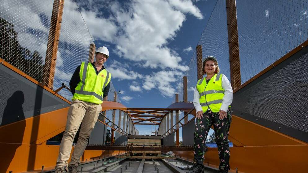 Project officer Michael Edwards with Transport for NSW regional director Anna Zycki standing on a span of a Jesmond footbridge to be opened soon. Yesterday's budget included $20 million in planning funding for the "missing section" behind the John Hunter Hospital. Picture: Marina Neil