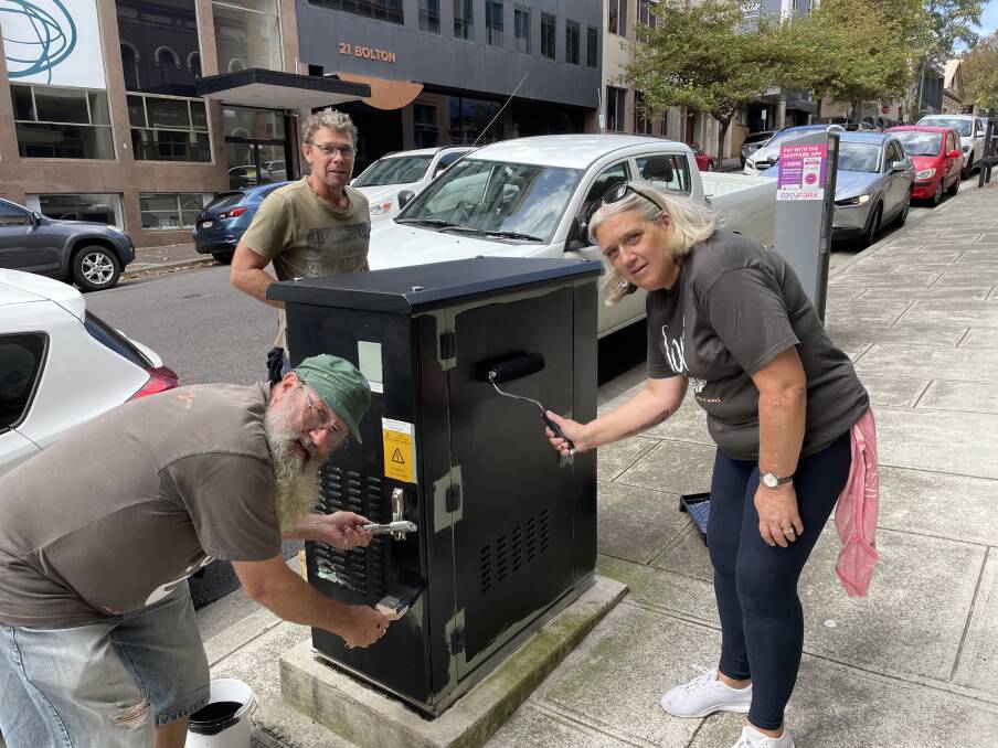 THE LITTLE THINGS COUNT: Sue Prosser of Soul Cafe with other volunteers attend to an NBN broadband box in Bolton Street. Picture: Ian Kirkwood