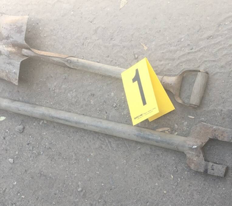 IMPLEMENTS:  The shovel used to lever the truck tailgate open, and the pipe spanner used to prop it in place.