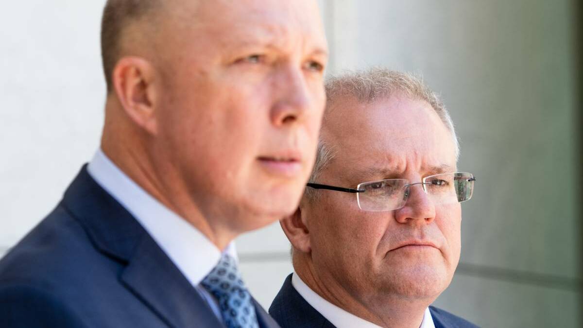 KHAKI ELECTION: Defence Minister Peter Dutton and Prime Minister Scott Morrison. Both men have made hawkish statements since Sunday on 'standing up' to 'autocratic regimes'.