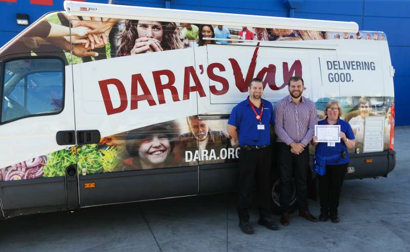 BEFORE CORONAVIRUS: Rutherford Officeworks staff Jay Kilian and Leonie Priest flanking Baden Ellis in 2018 after a fundraising effort for the Carrie's Place refuge and the DARA van. Picture: Jonathan Carroll