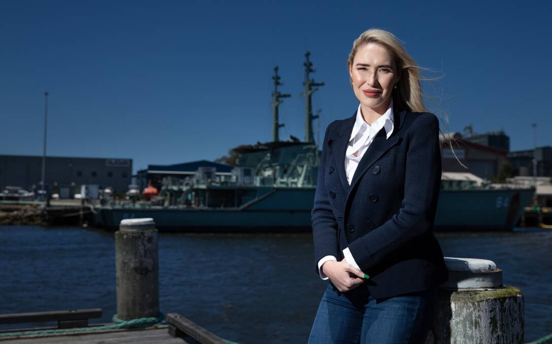 INDUSTRIAL ADVOCATE: Liberal Party candidate for Paterson, Brooke Vitnell, with a Naval vessel in the background at Carrington yesterday. Picture: Marina Neil