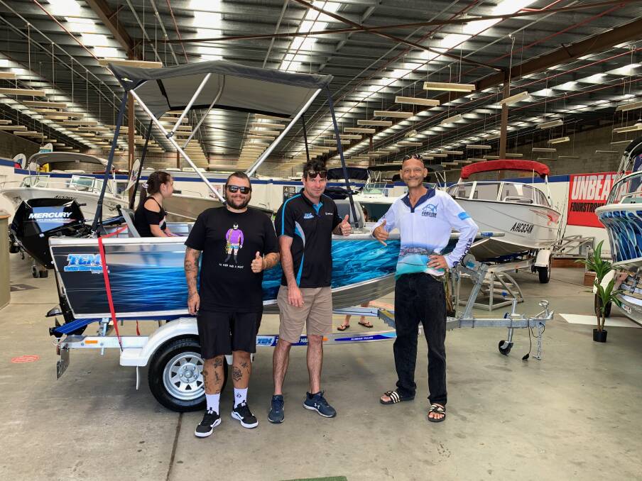 Willem Underman and Dan Andrew present an excited Dave Carter with his new boat.