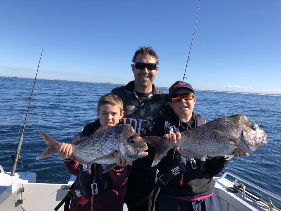 DOUBLE TROUBLE: Twins Henry and Hunter O'Neill with  father Michael win the prize this week for twin snappers  each caught off Broughton island recently.
