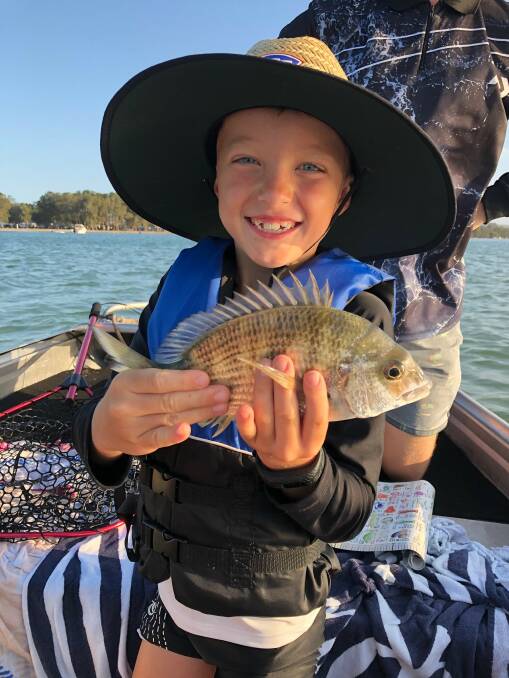 FISH OF THE WEEK: Oliver Low, 7, wins the prizes this week for his first ever legal fish (26cm bream) hooked recently during his first ever fishing trip in a tinnie on the lake.
